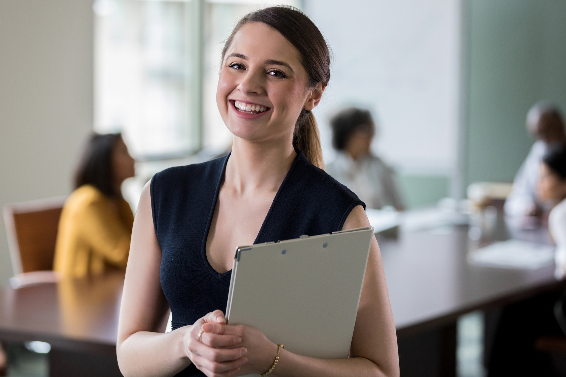 Portrait of cheerful administrative assistant before meeting